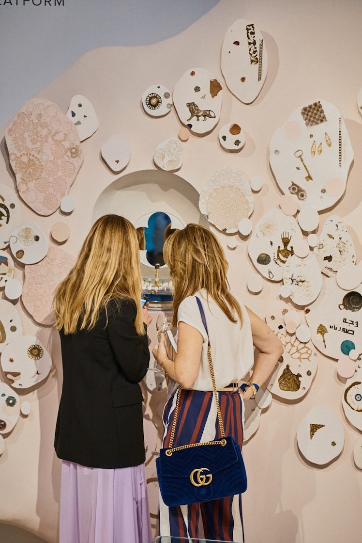 Visitors exploring a showcase of contemporary artworks at Art Basel Miami.