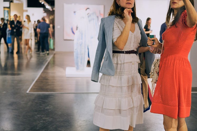 Two women wearing bright colors at Art Basel Miami international art fair