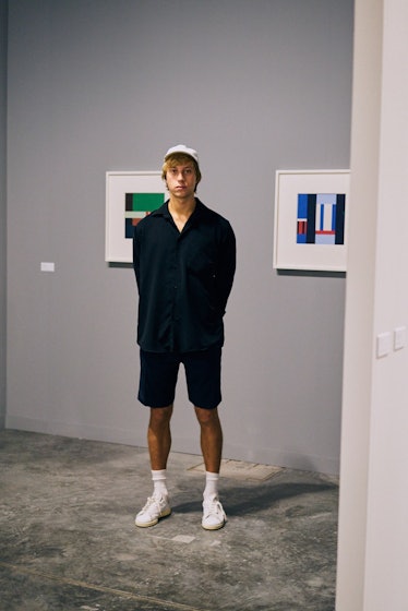 A man wearing a black co-ord set posing at the Art Basel Miami international art fair