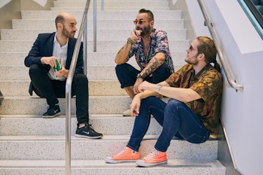 Visitors sitting at the stairs at Art Basel Miami international art fair