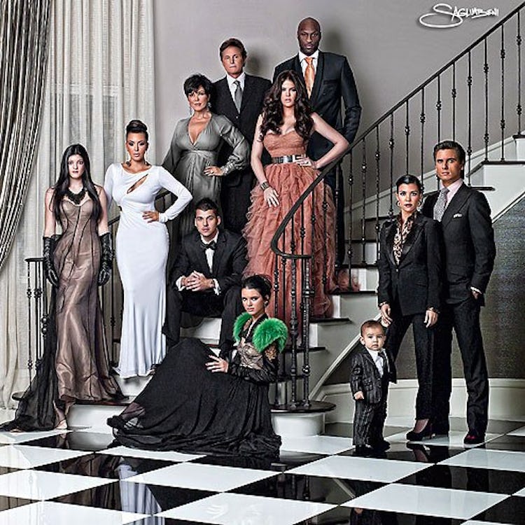 A Christmas card featuring the Kardashian-Jenner family gathered on and around a staircase