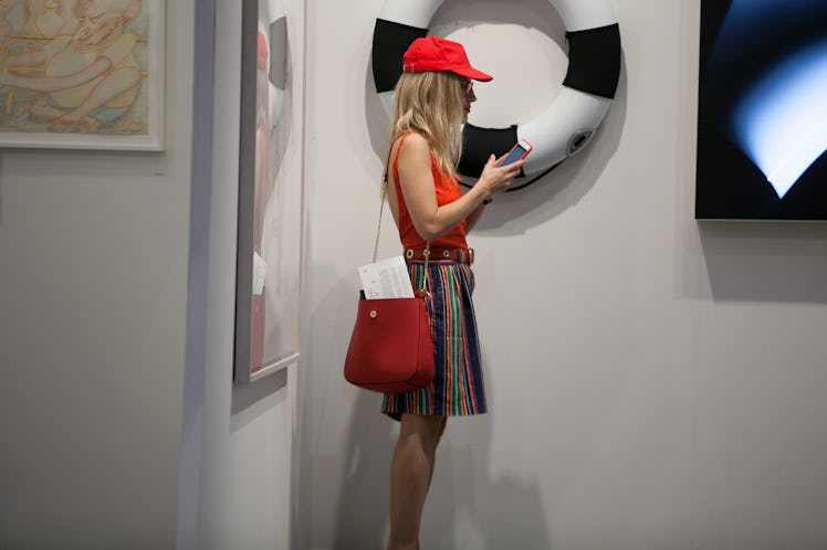 A woman wearing bright colors at Art Basel Miami international art fair
