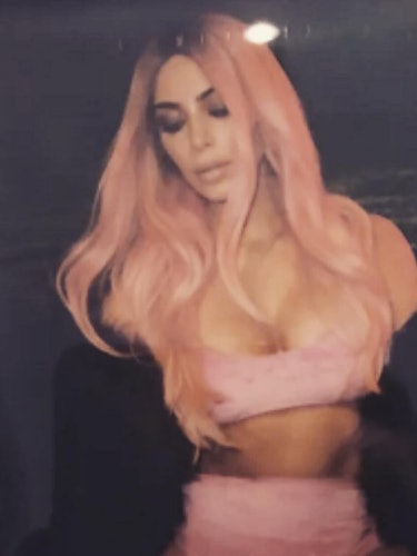 Kim Kardashian in a pastel pink top and skirt set, sporting pastel pink wavy hair 