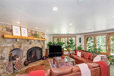 A living room with a fireplace in the Pulitzer Mansion in Mountain Village, Colorado.