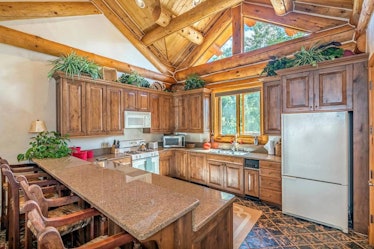 A kitchen and a dining area in the Pulitzer Mansion in Mountain Village, Colorado.