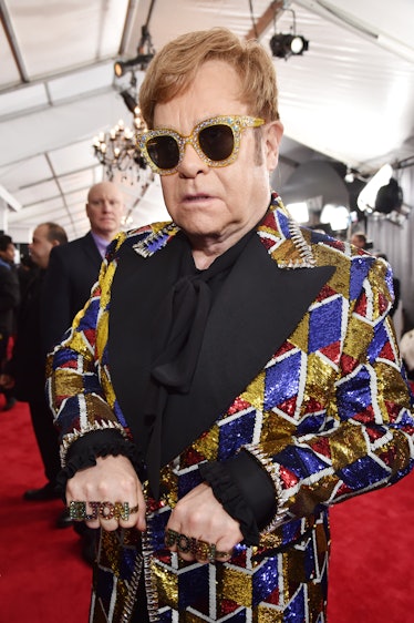 Elton John in a black suit with gold, blue, white, and red sequin elements at the Grammys 2018