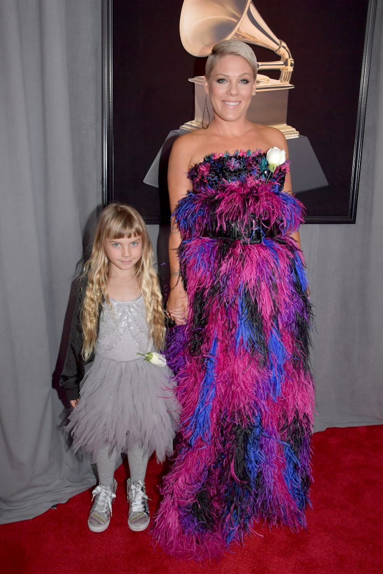 Pink in a black-pink-blue feather dress and her daughter in a grey dress at the Grammys 2018