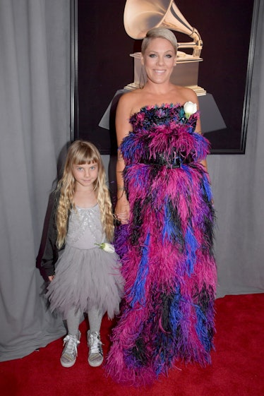 Pink in a black-pink-blue feather dress and her daughter in a grey dress at the Grammys 2018