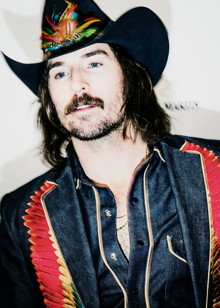 Mark Wystrach in a denim-red-yellow jacket and matching cowboy hat at the 2018 Grammy Award After Pa...