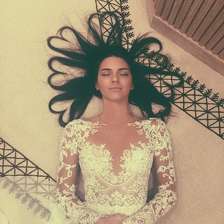 Kendall Jenner lying on the floor with her hairs being shaped as hearts