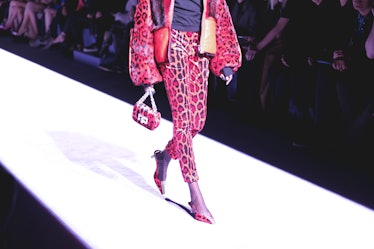 A female model walking in a purple jacket and pants combination on the runway at the Tom Ford Fall 2...