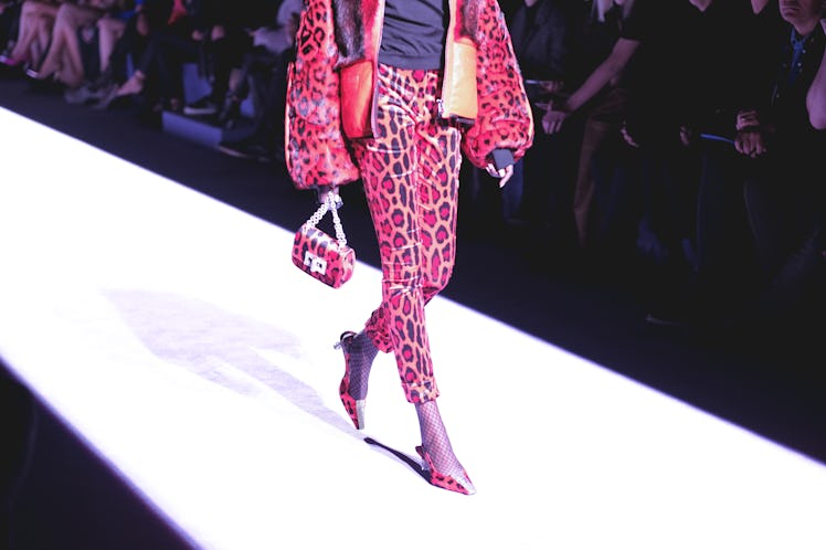 A female model walking in a purple jacket and pants combination on the runway at the Tom Ford Fall 2...