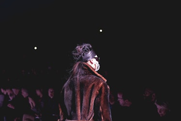 A model wearing a black and brown coat on the runway at the Tom Ford Fall 2018 show