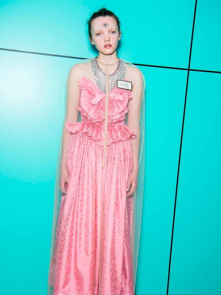 A model wearing a long pink dress at the Gucci Fall 2018 runway show 