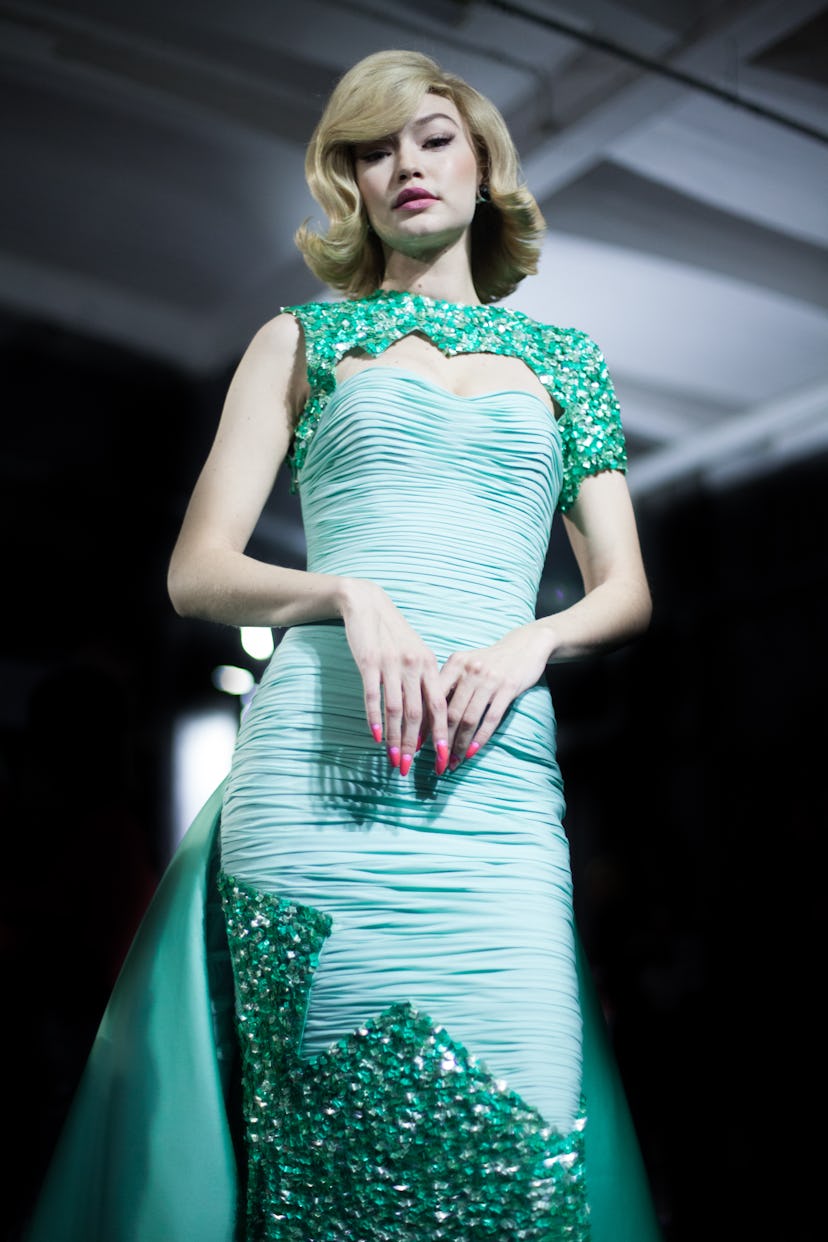 Gigi Hadid posing in a light green gown