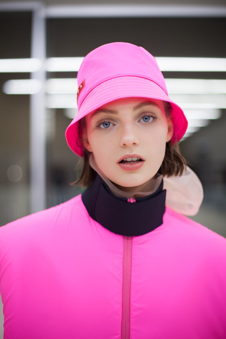 A model wearing a pink hat and a matching  jacket at the Prada Fall 2018 show during Milan Fashion W...
