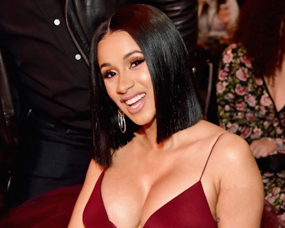 PHOTO: Cardi B flashes her ample cleavage in a neon dress while