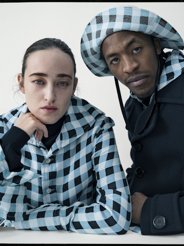 Mavi Staiano in a blue-black checked shirt and James Massiah in a black jacket and blue-black checke...
