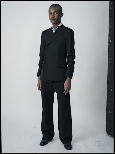 Maximillian Davis in a black suit from the Wales Bonner Fall collection