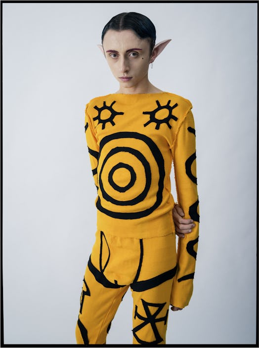 Lucas Nettleton-Tate in a yellow and black outfit with sun print by Charles Jeffrey