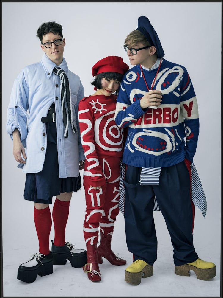 Jordan Hunt, Masumi Saito and Gary Card standing and posing while dressed by Charles Jeffrey