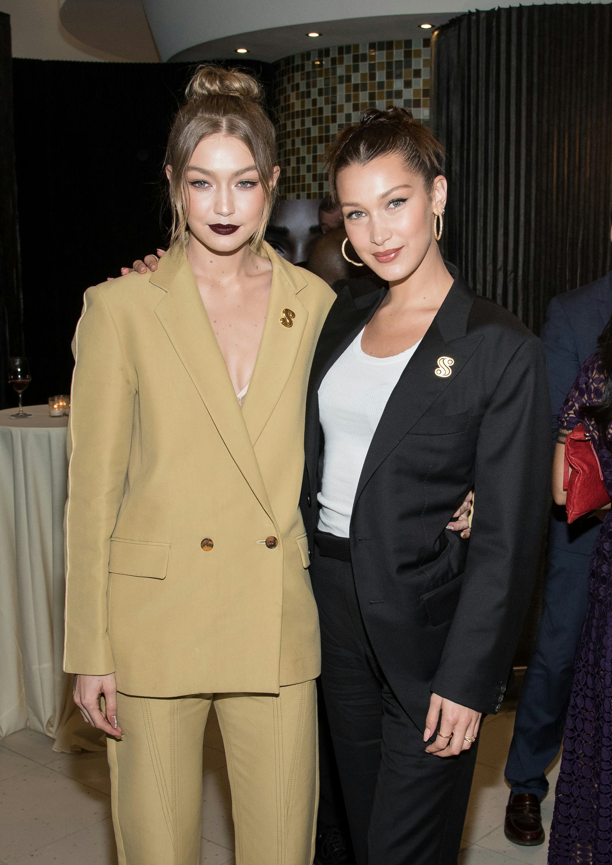 Bella and Gigi Hadid Wear Matching Pantsuits and ‘S’ Pins to Premiere