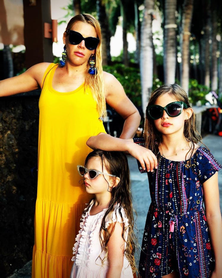 Busy Philipps, one of the savviest celebrity moms on social media, in a yellow dress and her two dau...