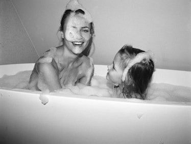 Mom supermodel, Natasha Poly, in bubbly bath with her daughter Aleksandra.