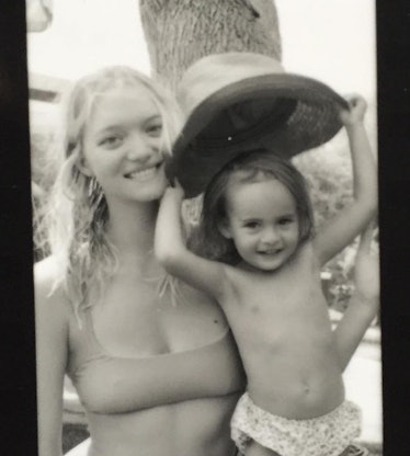 Black and white photo of mom supermodel, Gemma Ward, on the beach with her daughter.