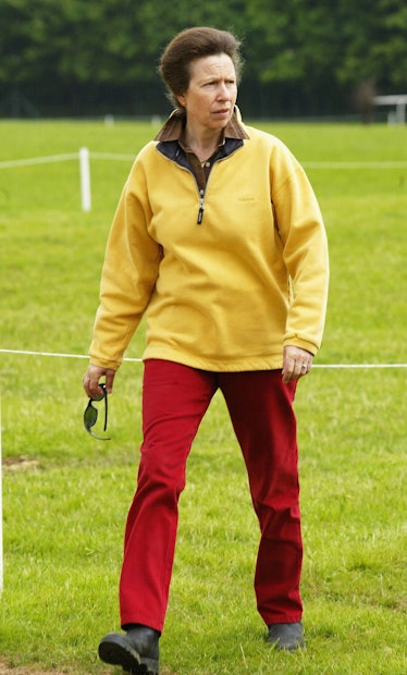 Princess Anne wearing a yellow top and red pants