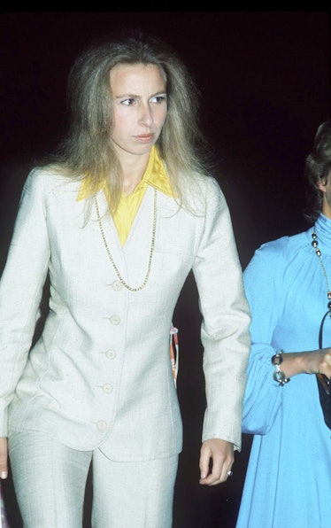 A young Princess Anne wearing a white suit with a yellow shirt