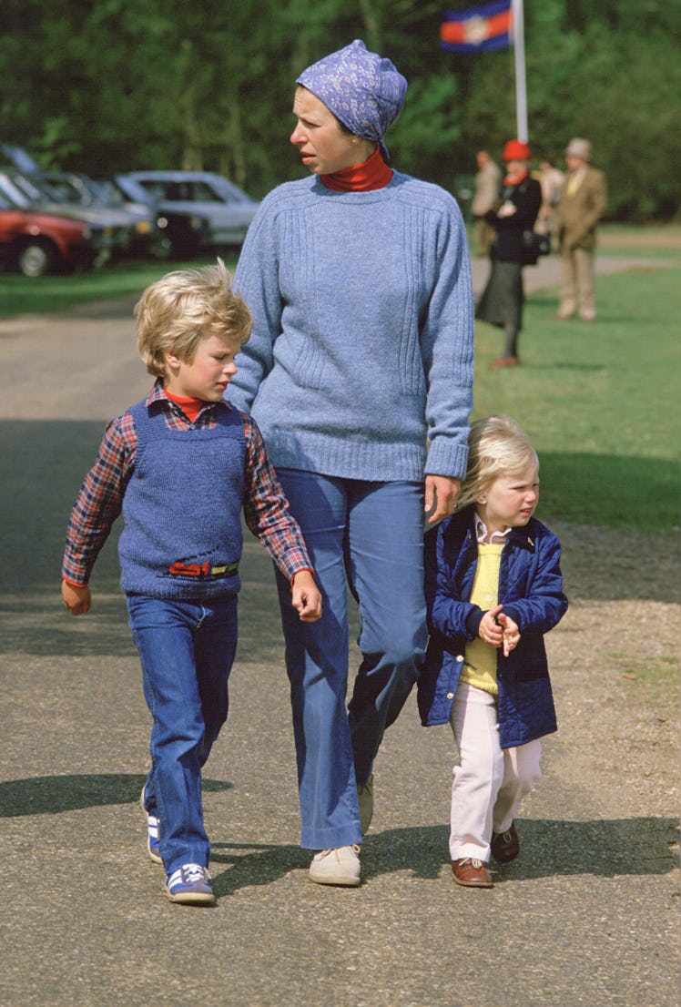 Princess Anne and two of her children wearing  blue