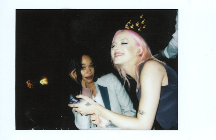 Laura Harrier in a white-black blazer and Bria Vinaite in a black top