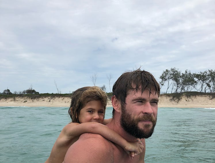 An Instagram post with Chris Hemsworth with his daughter on his back while swimming in the sea