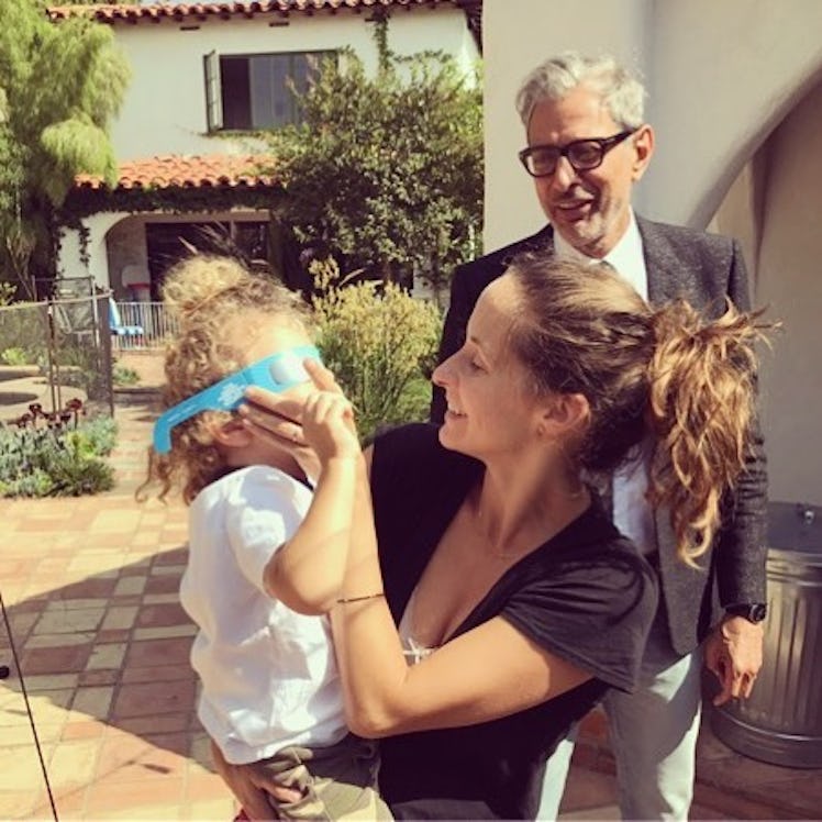 An Instagram post with Jeff Goldblum looking at Emili Goldblum holding their daughter and smiling