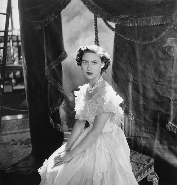 Queen Elizabeth II wearing a white dress with pearls photographed by Cecil Beaton