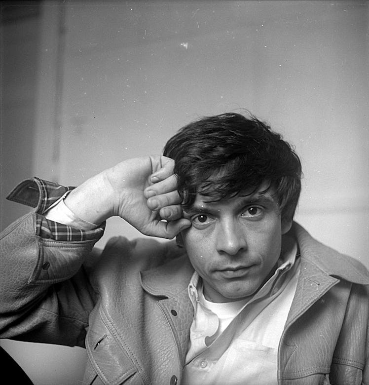 David Bailey leaning his head on his hand photographed by Cecil Beaton