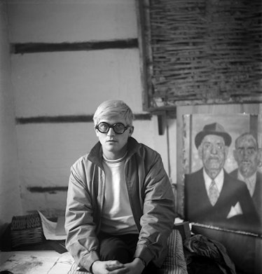 David Hockney sitting in front of his painting photographed by Cecil Beaton