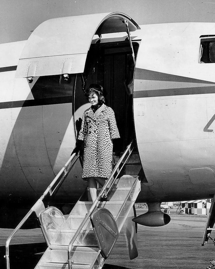 Jackie Kennedy getting off an airplane in a leopard-print coat.