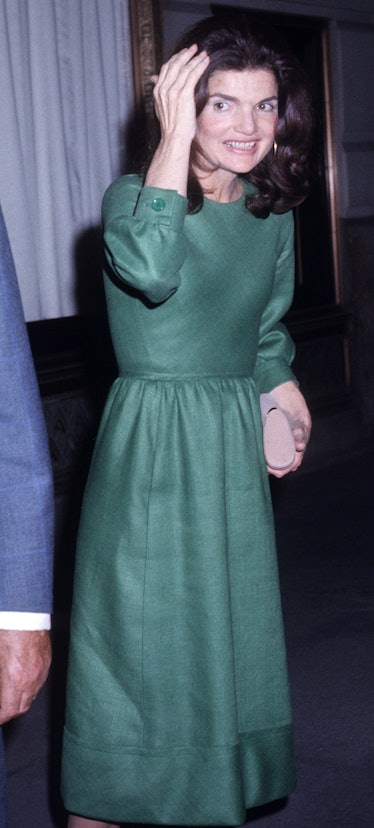 Jackie O in a high-necked green cocktail dress.