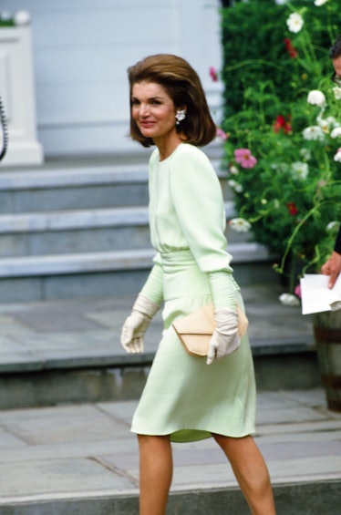 Jackie O at her daughter's wedding in a mint green dress and white gloves. 