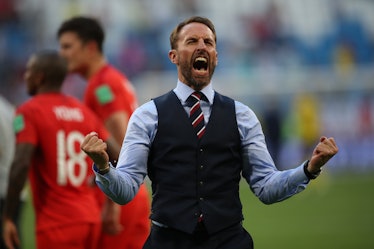 Gareth Southgate celebrating the win over Sweden in World Cup Quarter Finals 2018 while wearing a bl...