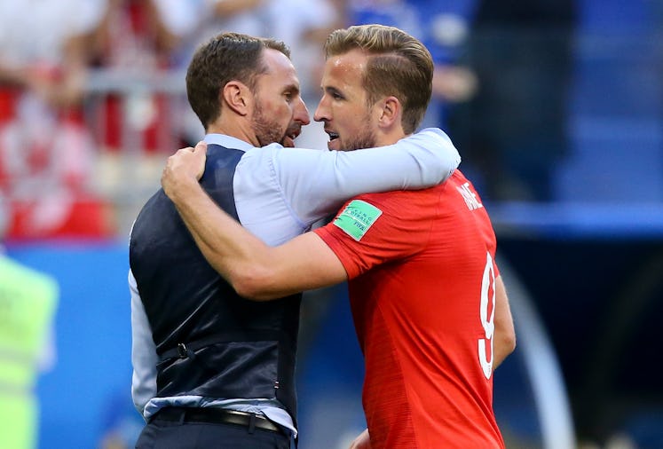 Gareth Southgate in a black waistcoat hugging Harry Kane after winning the Quarter Final 2018 World ...