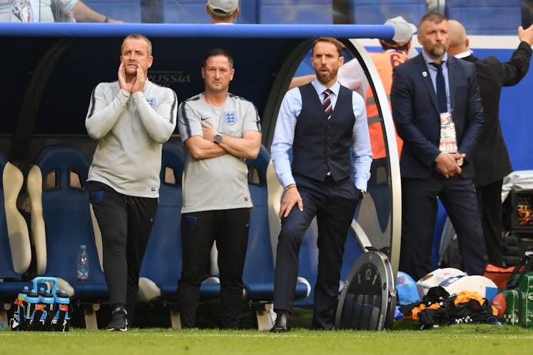 Gareth Southgate standing in a waistcoat at the coach bench during the Sweden v England Quarter Fina...