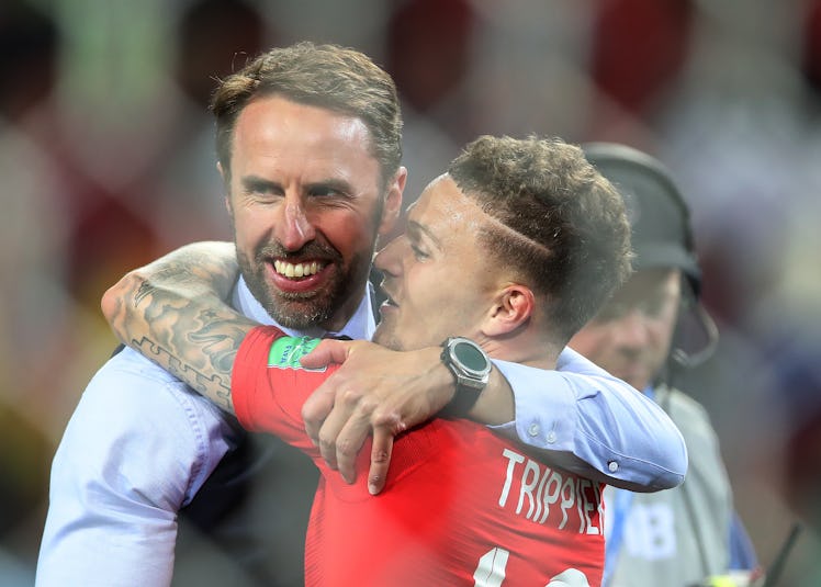 Gareth Southgate in a black waistcoat hugging Kieran Trippier after winning the Round of 16 Colombia...