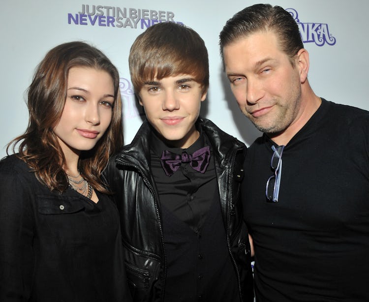 Young Hailey Baldwin and Justin Bieber posing for a photo with Stephen Baldwin.