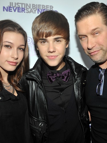 Young Hailey Baldwin and Justin Bieber posing for a photo with Stephen Baldwin.