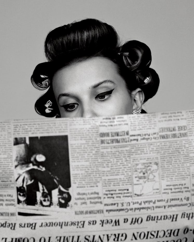 Millie Bobby Brown reading newspapers 