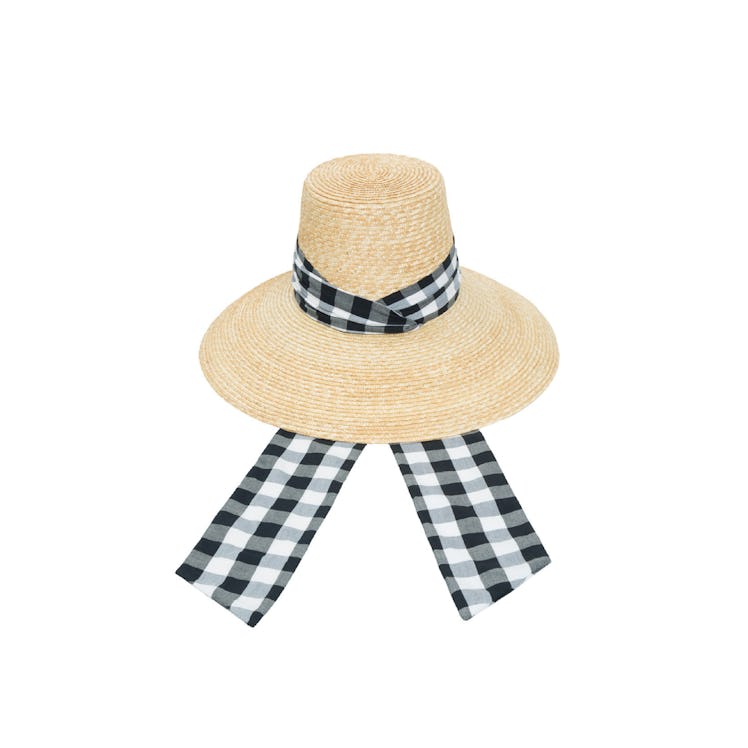 A straw hat with a black-white gingham print scarf-like element by LHD x Maison Michel