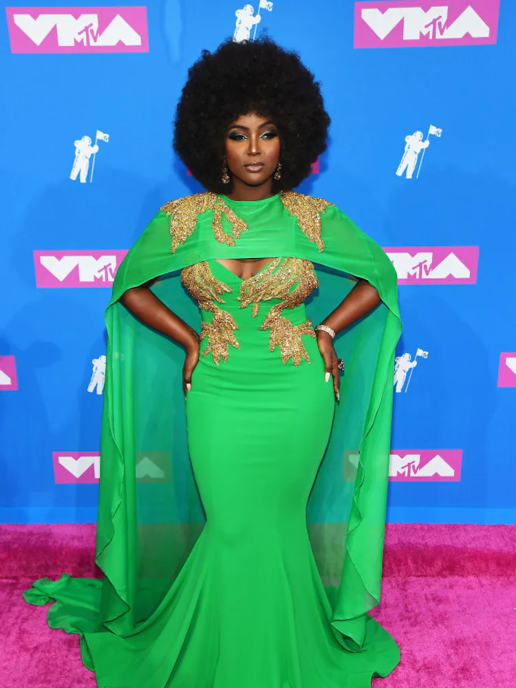 jlo vmas green dress Lets talk about one of the most iconic moments in fashion history: Jennifer Lopezs green Versace dress. , When JLo stepped onto the red carpet at the 2000 Grammy Awards wearing that plunging